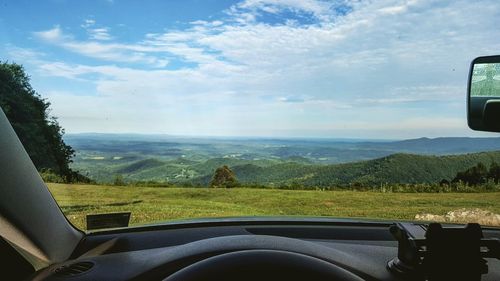 Scenic view of landscape seen through car windshield