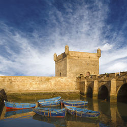 Arch bridge over river against sky