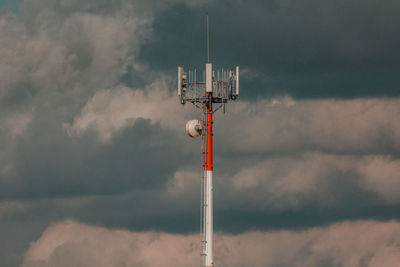 Low angle view of communications tower against sky