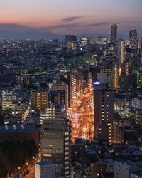 High angle view of illuminated city buildings at night