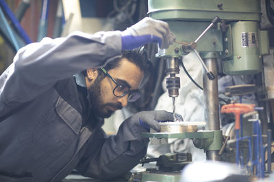 Young plumber technician working in workshop