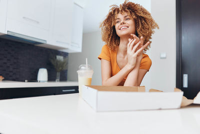 Portrait of young woman sitting in bathroom