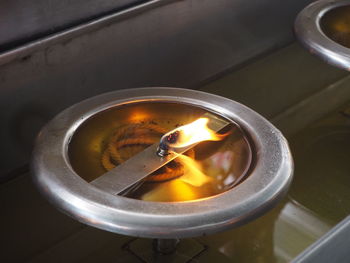 High angle view of tea cup on barbecue grill