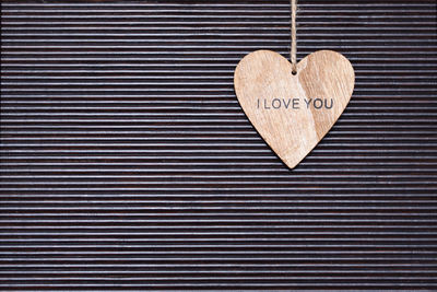 Heart shape with i love you text hanging on wall