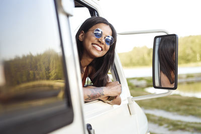 Woman leaning out of camper van window