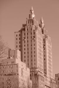 Buildings in city against clear sky