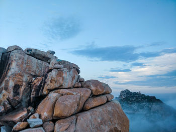 Low angle view of rock formation against sky