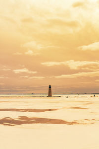 Scenic view of beach against sky during sunset