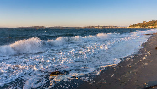 A view of alki beach in west seattle, washington on a windy day.