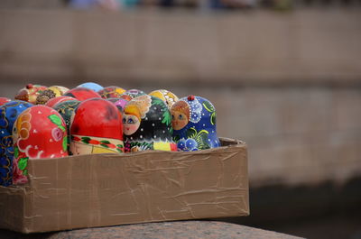 Close-up of matryoshka dolls in box on retaining wall