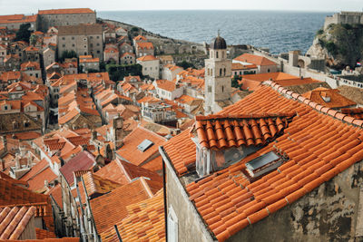 High angle view of city by sea against sky