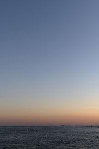 Scenic view of sea against clear sky during sunset