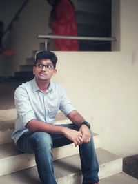 Portrait of young man sitting at home