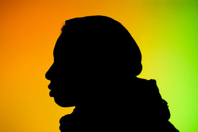 Silhouette of man against yellow background