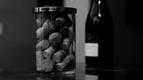 Close-up of wine cork in glass jar on table