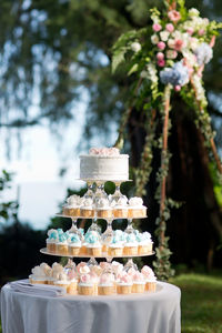 Cake on table against trees