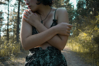 Close-up of woman holding tree trunk