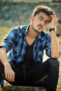 Portrait of young man sitting outdoors