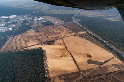 High angle view of airplane flying over field