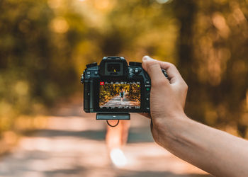 Midsection of person holding camera phone