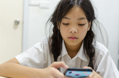 Portrait of cute girl using mobile phone