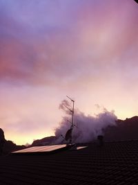 Silhouette of building against cloudy sky