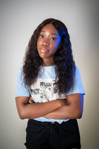 Portrait of a young woman against white background