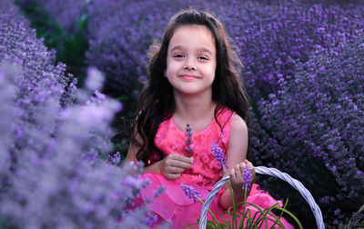 Portrait of smiling girl with purple flower