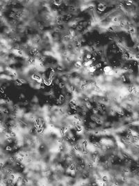 Full frame shot of raindrops on wet glass