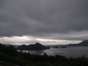 Scenic view of sea and mountains against sky