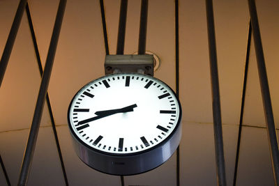 Low angle view of clock hanging on wall