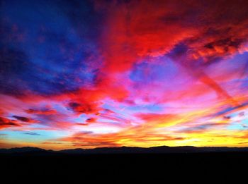 Silhouette of landscape against cloudy sky