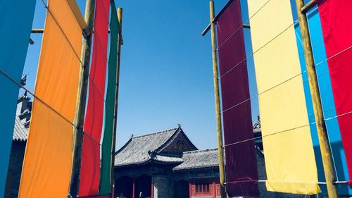 Low angle view of multi colored built structure against sky