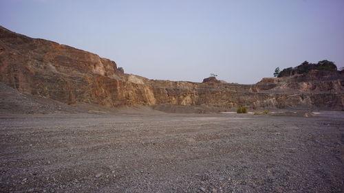 Scenic view of arid landscape against clear sky