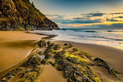 Surface level of calm beach against the sky