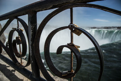 Close-up of  railing against river