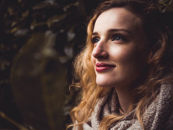 Close-up of smiling woman looking away