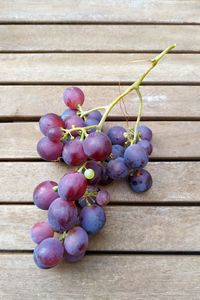 High angle view of grapes on wooden table