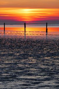 Scenic view of sea against orange sky