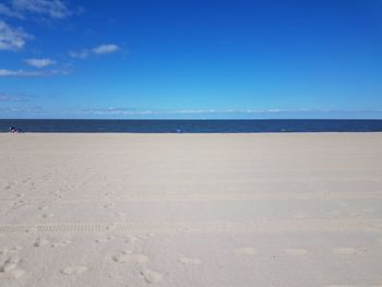 Scenic view of beach against clear blue sky