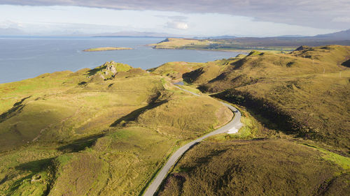 High angle view of road by land against sky