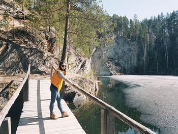 Man standing on footbridge