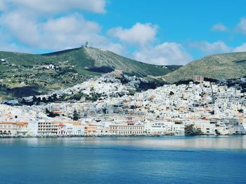 Aerial view of town by sea against sky