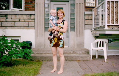 Full length of mother and daughter standing outdoors