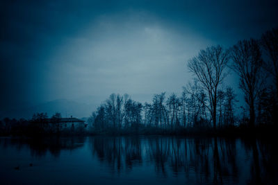 Scenic view of lake against sky at night