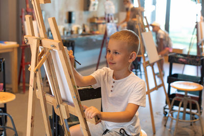 Portrait of boy sitting on chair