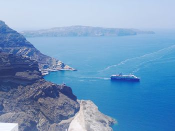 Scenic view of sea and mountains against sky