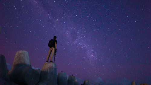 Low angle view of illuminated statue against sky at night