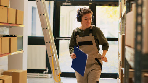 Portrait of young woman standing in library