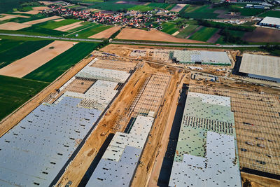 Construction site with steel frame structure of warehouse building, aerial view